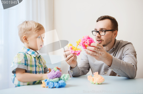 Image of father and son playing with ball clay at home