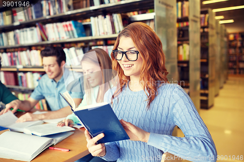 Image of students with books preparing to exam in library