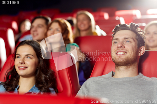 Image of happy friends watching movie in theater