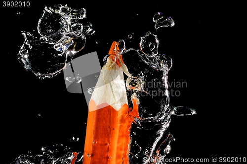 Image of Crayon under water with bubbles of air.