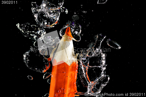 Image of Crayon under water with bubbles of air.