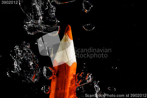 Image of Crayon under water with bubbles of air.