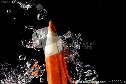 Image of Crayon under water with bubbles of air.