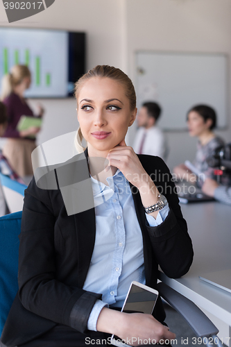Image of portrait of young business woman at office with team on meeting 