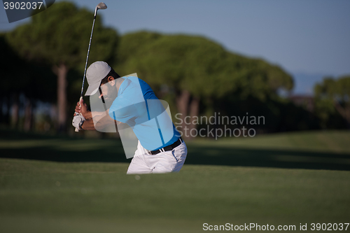 Image of pro golfer hitting a sand bunker shot