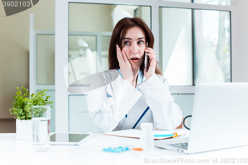 Image of Woman doctor sitting at the table