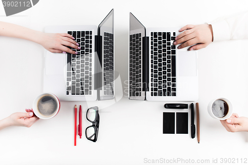 Image of Hands of people working in the office. Technology.