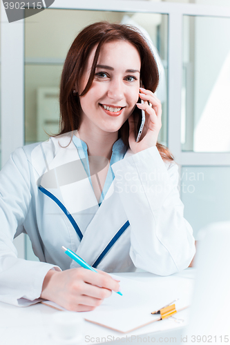 Image of Woman doctor sitting at the table