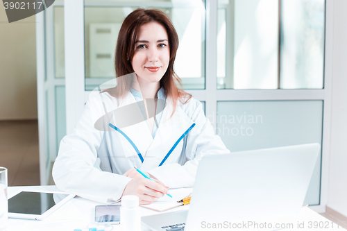 Image of Woman doctor sitting at the table