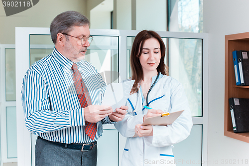 Image of The patient and his doctor in medical office