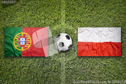 Image of Portugal vs. Poland flags on soccer field