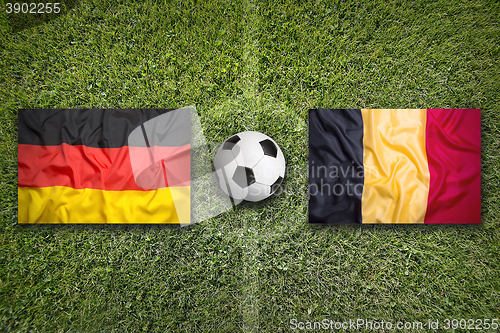 Image of Germany vs. Belgium flags on soccer field