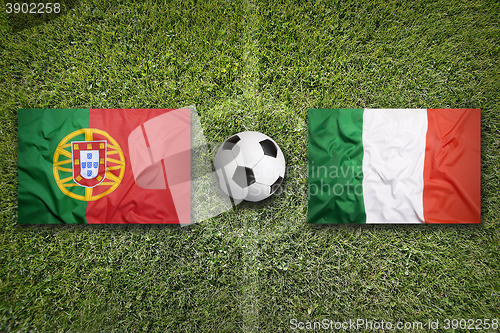 Image of Portugal vs. Italy flags on soccer field