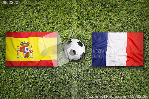 Image of Spain vs. France flags on soccer field