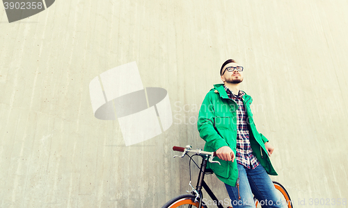 Image of happy young hipster man with fixed gear bike