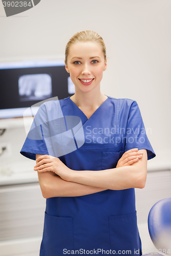 Image of happy female dentist at dental clinic office