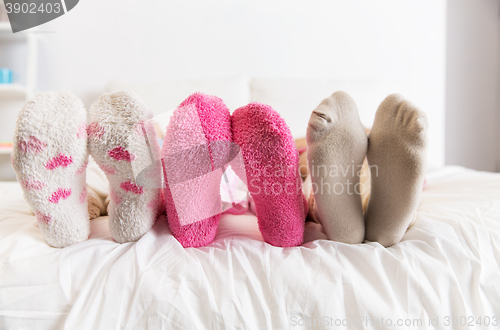 Image of close up of women feet in socks on bed at home