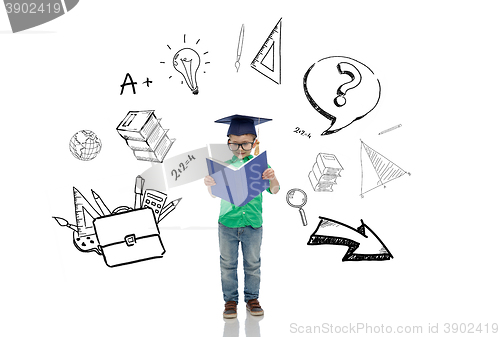 Image of boy in bachelor hat and eyeglasses reading book