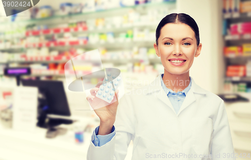 Image of woman pharmacist with pills drugstore or pharmacy