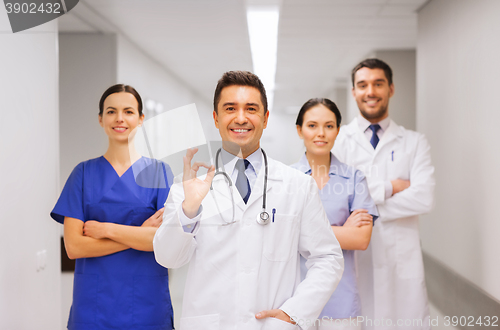 Image of group of medics at hospital showing ok hand sign