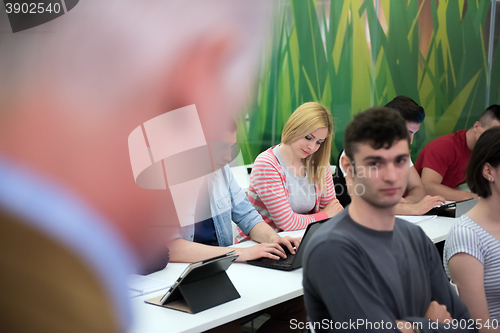 Image of teacher with a group of students in classroom
