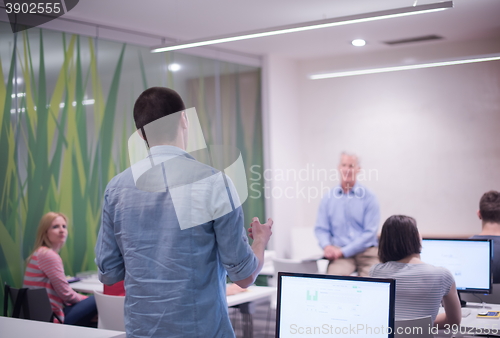 Image of student answering a question in classroom