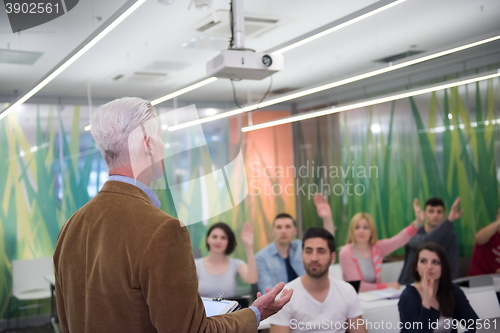 Image of teacher with a group of students in classroom