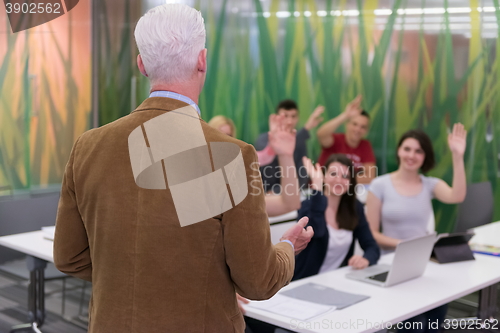 Image of teacher with a group of students in classroom