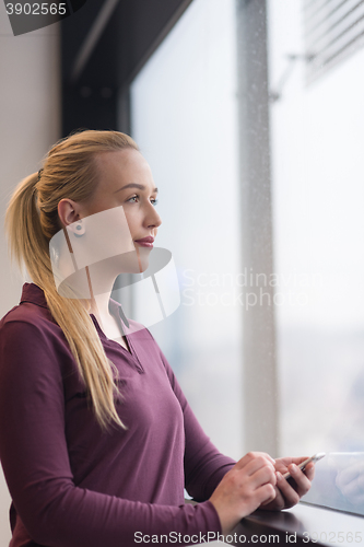 Image of business woman using smart phone at office