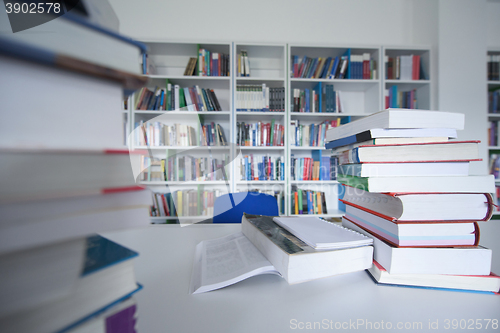 Image of female student study in library, using tablet and searching for 