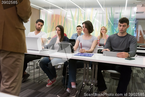 Image of teacher with a group of students in classroom