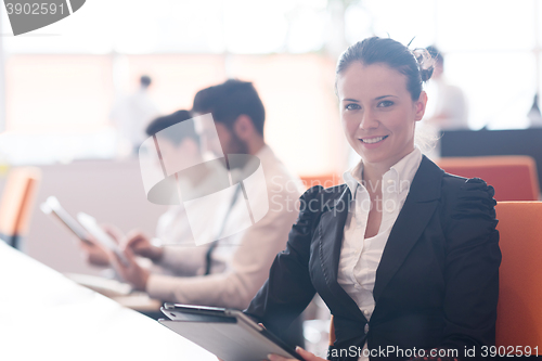 Image of business woman on meeting  using tablet