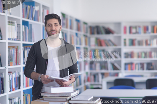 Image of portrait of student while reading book  in school library