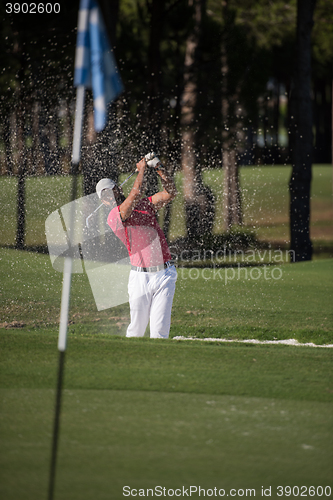 Image of golfer hitting a sand bunker shot