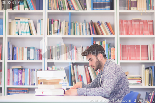 Image of portrait of student while reading book  in school library