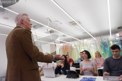 Image of teacher with a group of students in classroom