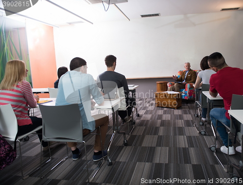 Image of teacher with a group of students in classroom