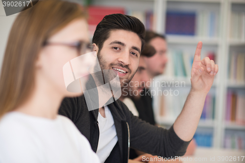 Image of group of students  raise hands up