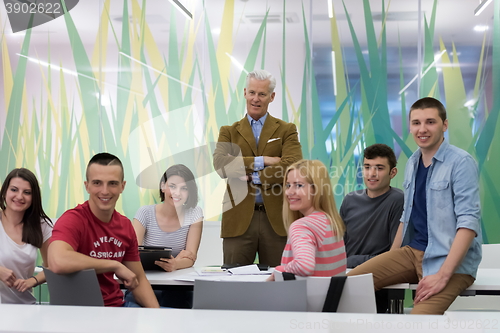 Image of portrait of  teacher with students group in background