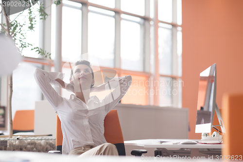 Image of happy young business woman relaxing and geting insiration