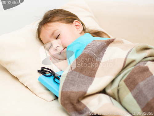 Image of Girl is sleeping with her book and glasses