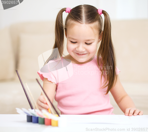 Image of Cute cheerful child play with paints