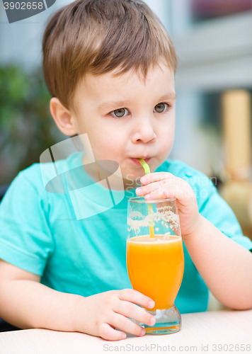 Image of Little boy with glass of orange juice