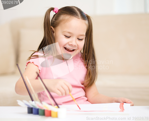 Image of Cute cheerful child play with paints