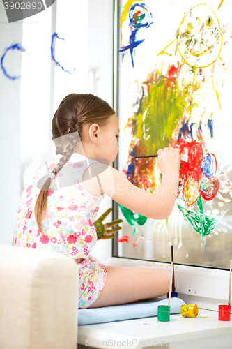 Image of Portrait of a cute girl playing with paints