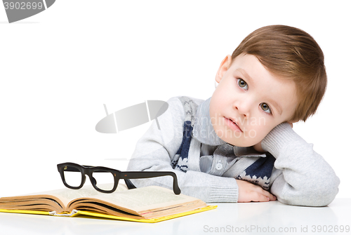 Image of Little child play with book