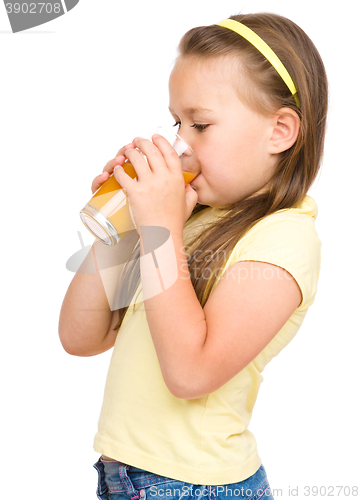 Image of Little girl is drinking orange juice
