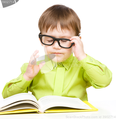 Image of Little child play with book