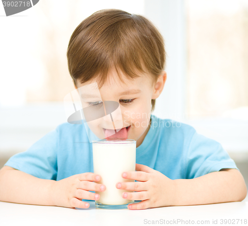 Image of Cute little boy with a glass of milk