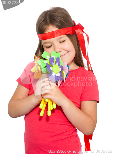 Image of Cute little girl wit a bunch of flowers